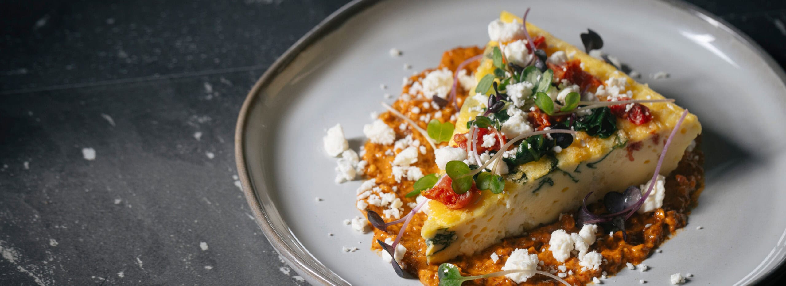 Silky veggie quiche showing vegetable puree and crumbled feta.